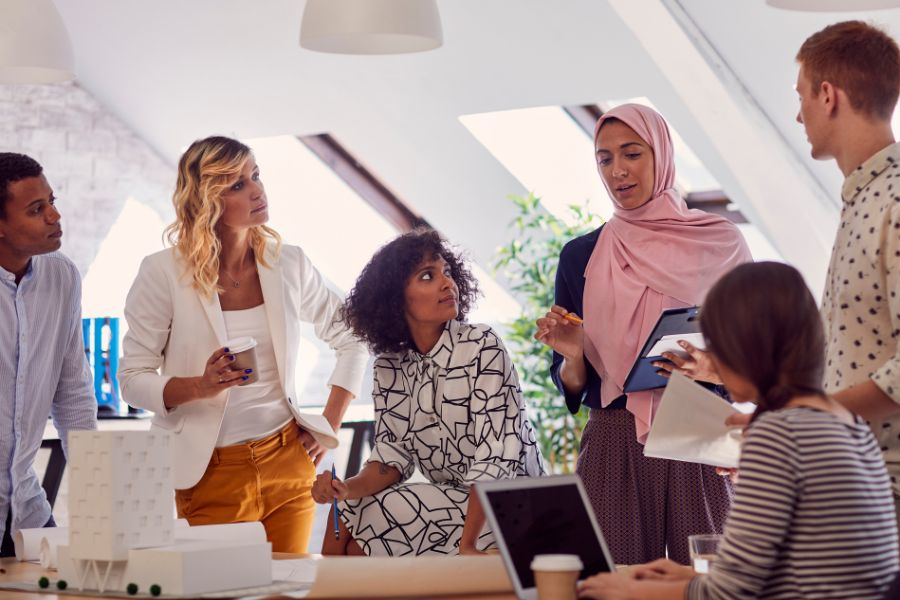 Diverse engineering team collaborating in a modern office meeting room