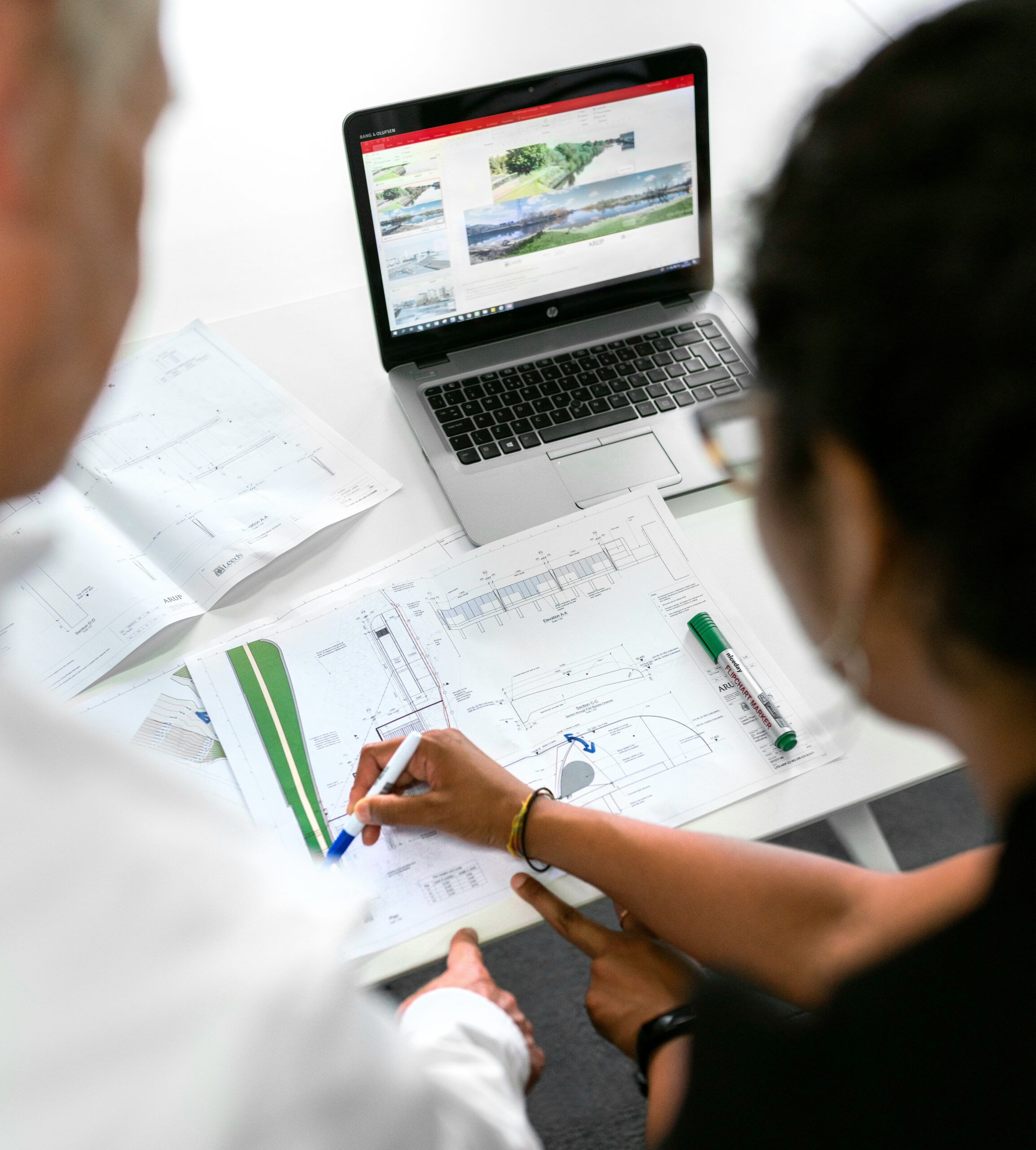 Engineer writing notes on white paper during a planning session